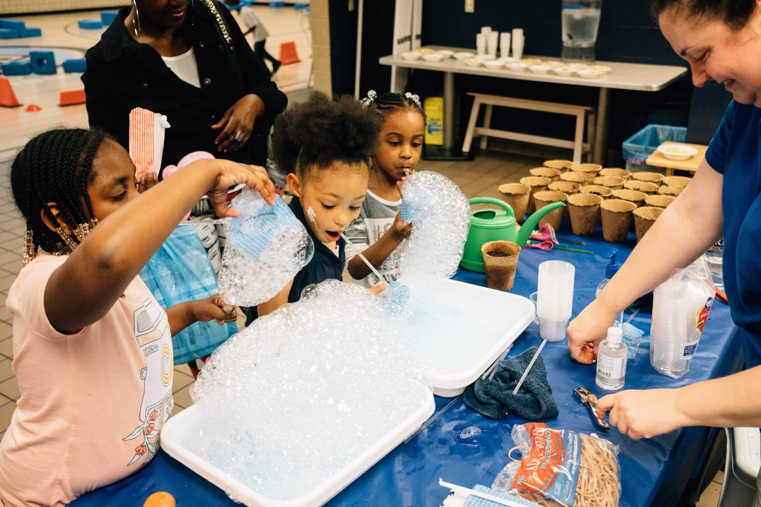 Photo of children using bubbles and dirt in a science activity.