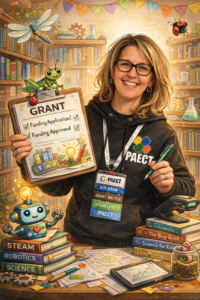 Woman with dirty blonde hair wearing glasses, long-sleeve black shirt, with clipboard and name tag with various roles she has as an educator